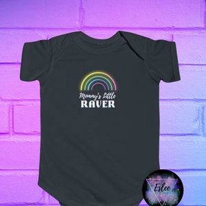 May include: A dark grey baby onesie with a rainbow graphic and the text "Mommy's Little RAVER" in white.