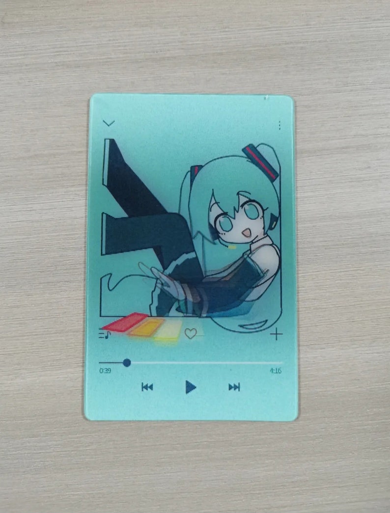 May include: A teal blue music player with a cartoon illustration of a green-haired anime character. The player has a play button, rewind and fast forward buttons, and a volume control. The time display shows 0:29 and 4:16.