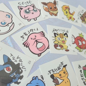 May include: A set of 10 colorful Pokemon character stickers with Japanese text. The stickers feature various Pokemon characters, including Pikachu, Jigglypuff, and Squirtle.