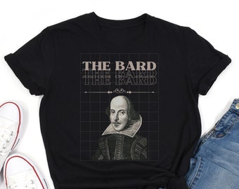 May include: Black t-shirt featuring a portrait of William Shakespeare with the text "THE BARD" in a repeating design. The graphic is set against a grid background. The shirt is paired with blue jeans and white sneakers.