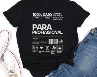 May include: Black t-shirt with white text that reads "100% GMO REAL FREE" and "PARA PROFESSIONAL". The shirt also has a graphic with the text "Contents may vary in accent, vibe and beliefs".