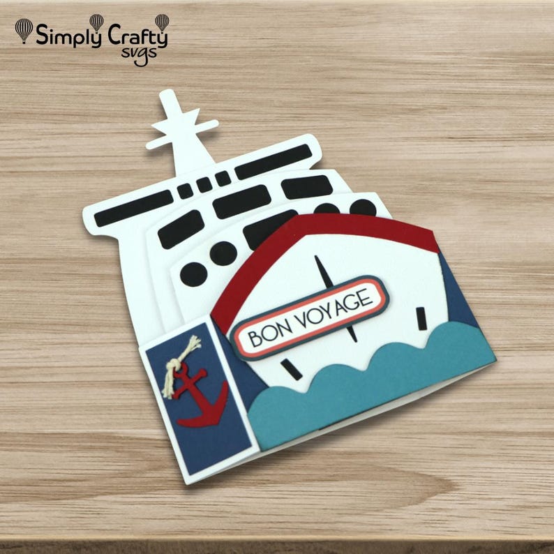 May include: A layered papercraft ship in white, red, and blue, with the words "BON VOYAGE" displayed. The design includes a red anchor on a blue panel and a white mast. The craft appears to be a card or decorative item.