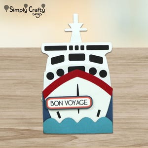 May include: A papercraft cruise ship in white, red, and blue, featuring the text "BON VOYAGE" on a sign. The ship has black windows and a white superstructure. The design includes blue waves at the bottom and a mast.