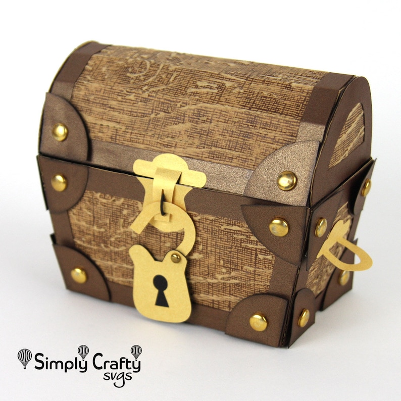 May include: A brown paper treasure chest with gold accents, a gold lock and key, and metal studs. The chest is closed and has a hinged lid.