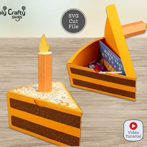 May include: Two papercraft cake slice boxes, one with a candle and the other open, revealing a card and candies. The boxes are orange and brown, resembling a cake. The top of the cake slice has a floral design. The image includes the text "SVG Cut File" and "Video Tutorial".