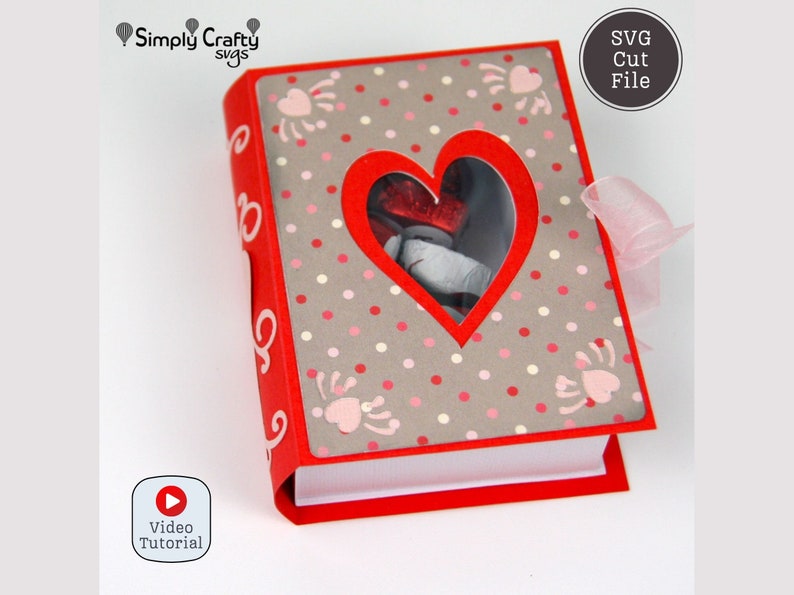 May include: A red and gray scrapbook-style box with a heart-shaped window. The cover features a polka dot pattern with heart and paw print designs. A pink ribbon is tied to the side. The text "SVG Cut File" is visible.