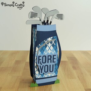 May include: A blue and white golf bag with a plaid pattern and a set of golf clubs sticking out of the top. The bag has a blue and white sign that says "FORE YOU".