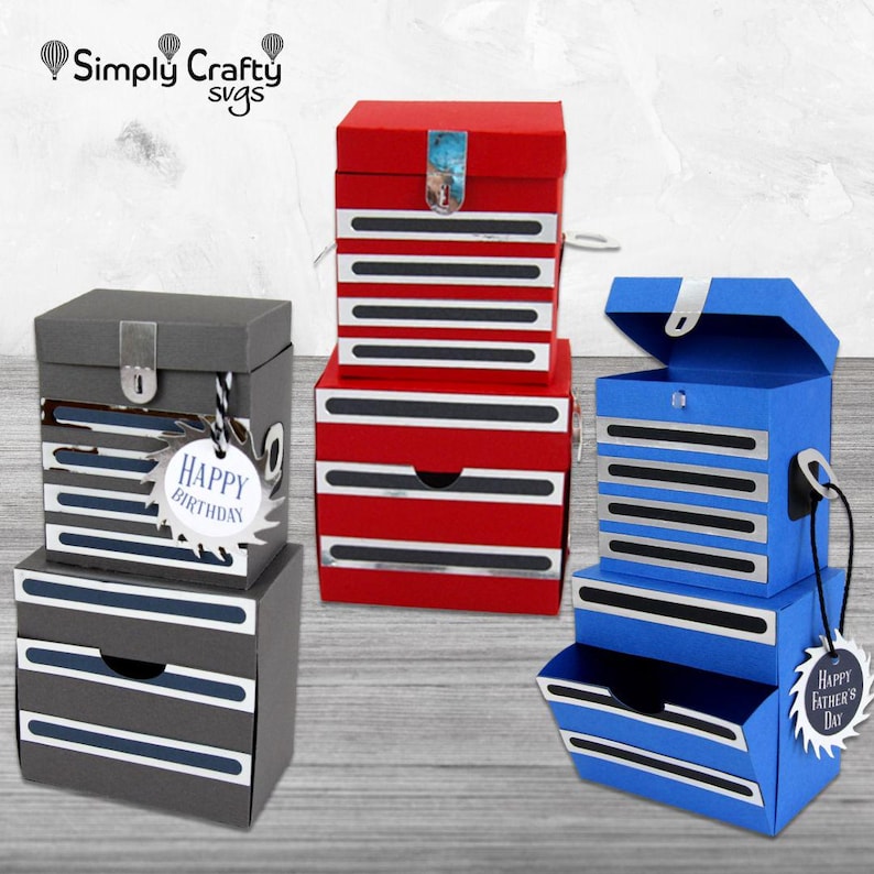 May include: Three decorative toolbox-shaped boxes in red, grey, and blue. Each box has a drawer and is decorated with silver and black stripes. The grey box has a "Happy Birthday" tag, and the blue box has a "Happy Father's Day" tag.