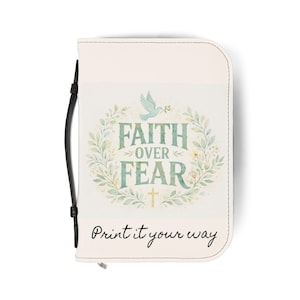 May include: Cream-colored Bible cover with a black handle and zipper. The cover features the text "Faith Over Fear" in green, surrounded by a floral wreath, and a dove carrying an olive branch. The phrase "Print it your way" is printed at the bottom.