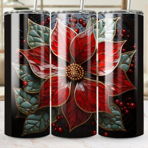 May include: A set of three stainless steel tumblers with a festive poinsettia design. The design features a large red flower with green leaves and gold accents against a black background. Each tumbler has a silver straw.