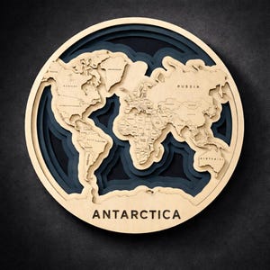May include: A round, layered wooden world map with a light wood finish. The map features detailed country outlines and is set against a dark blue and black background. The word "ANTARCTICA" is displayed at the bottom.