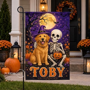 May include: A rectangular garden flag featuring a golden retriever wearing a purple witch hat sitting next to a skeleton holding a jack-o'-lantern. The background shows a full moon, bare trees, and bats. The name TOBY is printed in orange.