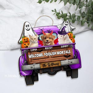 May include: A Halloween-themed wooden sign featuring a purple truck bed with three pets dressed in costumes. The sign reads "WELCOME, FOOLISH MORTALS" and includes the family name "The Williams". Two pumpkins and two ghosts are also featured.