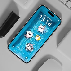 May include: A smartphone displays a whimsical pool scene with cartoon characters and a beach ball. The screen shows the date and time, 5/20 13:14. A white keyboard, wireless earbuds, and a mouse are visible on a gray surface.