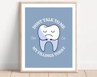 May include: A blue and white illustration of a tooth with a sad face. The text around the tooth reads "Don't talk to me I'm in my fillings today".