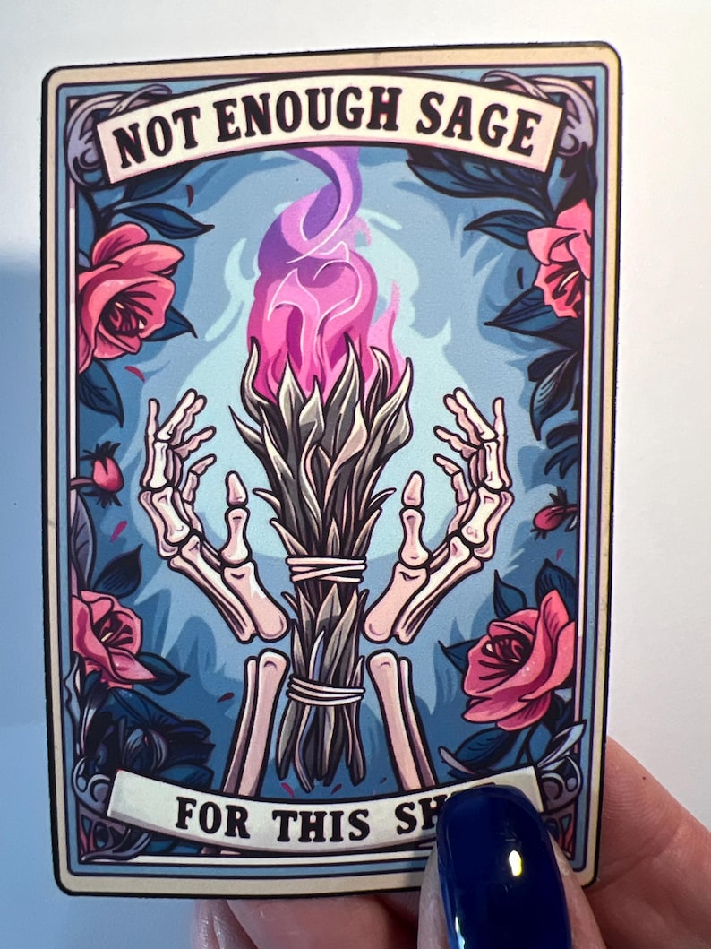 May include: A vintage-style card with a blue background and floral accents. The card features a skeletal hand holding a bundle of sage with pink flames. The text on the card reads "NOT ENOUGH SAGE FOR THIS SH", suggesting a magical or spiritual theme.