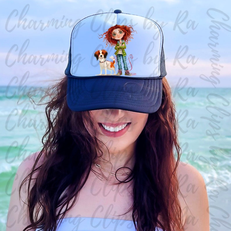 Puede incluir: Una mujer lleva una gorra de camionero negra y blanca con una ilustraci&oacute;n de dibujos animados de una ni&ntilde;a y un perro. La gorra tiene una parte trasera de malla y un panel frontal blanco.