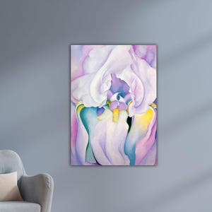 May include: A close-up of a floral painting featuring a large iris. The artwork showcases soft, flowing petals in shades of white, lavender, and purple, with accents of yellow and teal. The painting is mounted on a canvas.