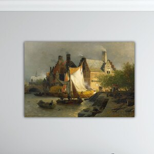 May include: A framed landscape painting depicts a waterside scene with buildings, boats, and figures. The artwork features a sailboat with a white sail, a small boat, and a building with a smoking chimney. The color palette includes browns, greens, and yellows.