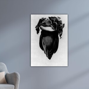 May include: Black and white art print of a flower, possibly a tulip, in a grayscale photograph. The flower's petals are tightly closed at the base, opening towards the top. The image is mounted on a white background.