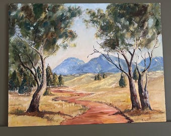 May include: A painting depicting a winding dirt road leading through a field towards a mountain range in the distance. The road is flanked by trees on either side, and the sky is a light blue with some clouds. The painting is executed in a realistic style with a warm colour palette.
