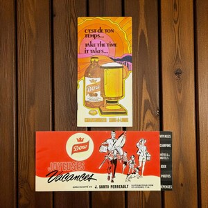 May include: Two vintage Dow beer adverts. The top one shows a bottle and a pint of beer with the text "Take the time it takes." The bottom one says "Joyeuses Vacances" with illustrations of people.