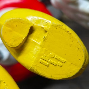 May include: Yellow plastic toy foot with a Disney copyright and "Applause 711 China" printed on the bottom.