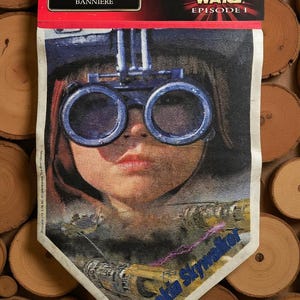 May include: A Star Wars Episode I banner featuring a portrait of Anakin Skywalker wearing blue goggles. The banner has the words "BANNER BANNIERE" at the top and "STAR WARS EPISODE I" on the right side.