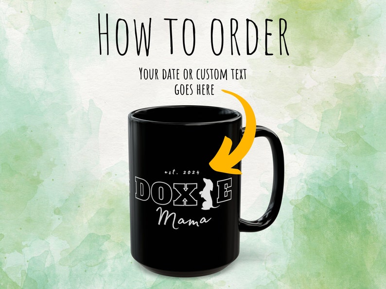 Black Doxie Mama mug with white lettering, highlighted with an arrow pointing to customization instructions.