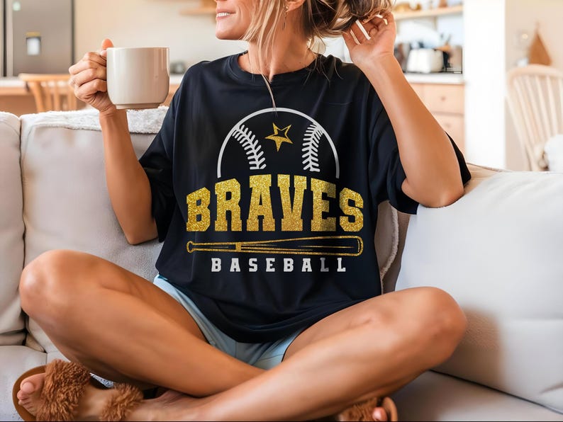 May include: A black t-shirt with a gold glitter design featuring a baseball, a star, and the words "BRAVES BASEBALL".