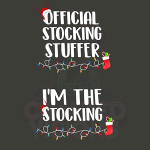 May include: A dark gray graphic with the text "OFFICIAL STOCKING STUFFER" and "I'M THE STOCKING" in white. The design includes a Santa hat, Christmas lights, and a red stocking with candy canes.