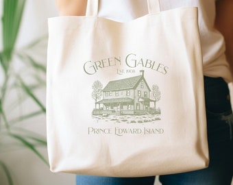 Puede incluir: Una bolsa de lona blanca con un gráfico verde de una casa y el texto "Green Gables Est. 1908 Isla del Príncipe Eduardo".