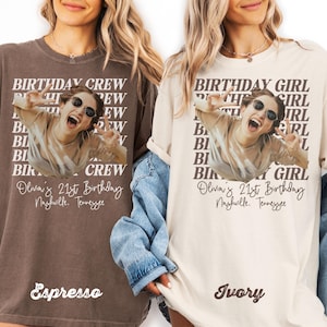 May include: Two t-shirts, one espresso-colored and one ivory-colored, featuring a photo of a person wearing sunglasses and making a peace sign. The text reads "BIRTHDAY CREW" and "BIRTHDAY GIRL" with the name "Olivia" and "21st Birthday" and the city "Nashville, Tennessee".