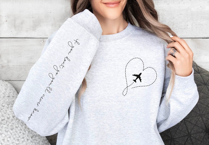May include: Gray sweatshirt with a heart-shaped airplane design and the text "I love you more than words can say" on the sleeve.