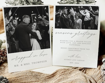 May include: A black and white photo of a couple dancing at their wedding reception. The photo is framed in a white border and has the text "wrapped in love" and "MR. & MRS. THOMPSON" below it. The text "seasons greetings" is written in cursive on a white background with the text "WISHING YOU A SEASON FILLED WITH LOVE, JOY, AND ENDLESS HAPPINESS. MERRY CHRISTMAS FROM THE NEWLYWEDS! with love AUDREY AND CARSON EST. 2024" below it.