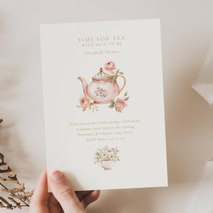 May include: A cream-colored invitation with the text "TIME FOR TEA WITH MOM TO BE" and "Elizabeth Thomas." It features a watercolor illustration of a pink teapot with roses. Additional text includes baby shower details.