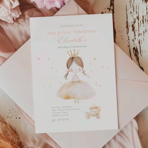 May include: A pale pink invitation card with the text "PLEASE JOIN US FOR HER ROYAL THREENESS Elizabeth's Birthday Celebration." The card features a watercolour illustration of a princess and a carriage.