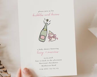 May include: Baby shower invitation with the text "bubbles and brews". The invitation features a champagne bottle and a baby bottle illustration in pink and green. The invitation includes the names "lucy + marcus" and event details.