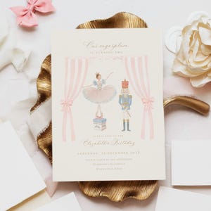 May include: A rectangular birthday invitation card featuring a watercolor illustration of a ballerina and a nutcracker between pink striped curtains. Text reads: Our sugarplum is turning two, Please join us for Elizabeth's Birthday, Saturday, 25 December 202X.