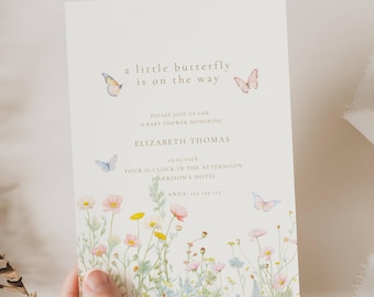 May include: A baby shower invitation with a floral and butterfly design. The text reads "a little butterfly is on the way" and includes details for Elizabeth Thomas's baby shower. The invitation features watercolor illustrations of butterflies and wildflowers.