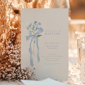 May include: A baptism invitation card with a watercolor illustration of blue flowers and a ribbon. The text reads "please join us for the BAPTISM of our beloved son MATTHEW THOMAS". Includes date, time, and location details.