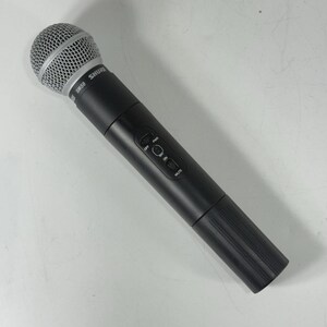 May include: A black Shure SM58 microphone with a silver mesh head. The microphone has a cylindrical body with an on/off switch and a mute button. The microphone is designed for vocal performances and recording.