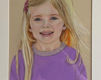 May include: A framed portrait of a young girl with long blonde hair and blue eyes. She is wearing a purple long-sleeved shirt and a pink hair accessory. The artwork is set against a neutral background.