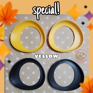 May include: Two yellow and two black circular eye-shaped frames with a slanted design. The text FALL SEASON special! is at the top, with YELLOW and BLACK labels below each pair. A small logo with an otter and the text OTTER HALF COSTUMES is visible.