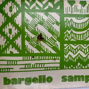 May include: A rectangular paper print featuring a green and white geometric pattern with various linear and zigzag designs. The text "bargello sampler" is printed in bold green lowercase letters at the bottom of the off-white background.