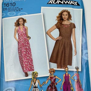 May include: A Simplicity sewing pattern packet featuring a Project Runway design. The cover is blue and displays images of dresses in various styles, including a halter maxi dress and a brown dress. The pattern number is 1610.