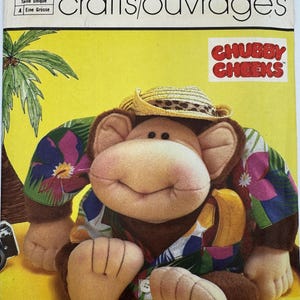 May include: A Simplicity 7415 sewing pattern envelope for a Chubby Cheeks monkey doll named Waikiki Willie. The cover features a plush monkey wearing a straw hat and a colorful floral shirt with a banana, set against a yellow background.