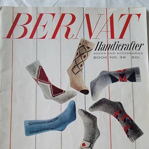May include: A vintage Bernat Handicrafter book cover featuring colorful socks hanging from yarn holders. The book is titled "Handicrafter Socks and Accessories" and is Book No. 36, priced at 50 cents.