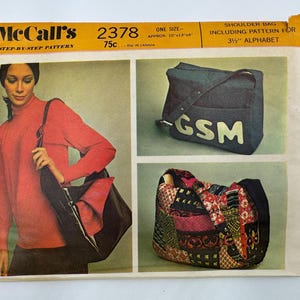 May include: A McCall's 2378 sewing pattern envelope for a shoulder bag. The front features illustrations of a dark bag with the letters GSM, a patchwork bag, and a person carrying a bag. Text includes McCall's 2378, One Size, and 3.5 inch alphabet.