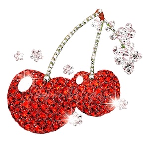 May include: A sparkling illustration of two cherries, each covered in red rhinestones. The stems and small flower accents are encrusted with clear rhinestones. The design is set against a white background, creating a glamorous and eye-catching effect.